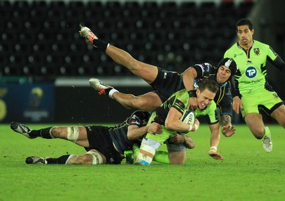 180115 - Ospreys v Northampton Saints - European Rugby Champions Cup -James Wilson of Northampton is tackled by Josh Matavesi and Justin Tipuric