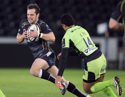 180115 - Ospreys v Northampton Saints, 2014-15 European Rugby Champions Cup - Ospreys Dan Evans takes on Northampton's Ken Pisi