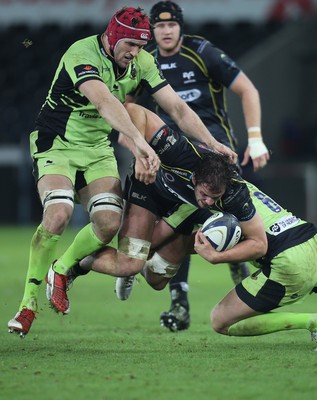 180115 - Ospreys v Northampton Saints, 2014-15 European Rugby Champions Cup - Ospreys Tyler Ardron is tackled by Northampton's Tom Wood and Christian Day