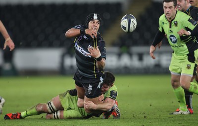 180115 - Ospreys v Northampton Saints, 2014-15 European Rugby Champions Cup - Ospreys Josh Matavesi feeds the ball out as he's tackled