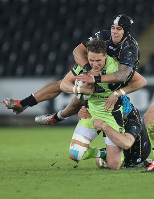 180115 - Ospreys v Northampton Saints, 2014-15 European Rugby Champions Cup - Northampton's James Wilson is tackled by Ospreys Josh Matavesi and Justin Tipuric