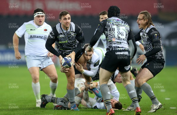 130118 - Ospreys v Saracens - European Rugby Champions Cup - Ashley Beck of Ospreys is tackled by Liam Williams of Saracens