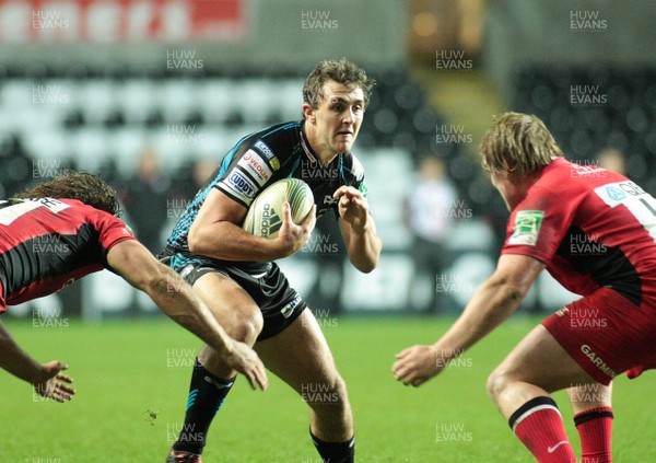 16.12.11 Ospreys v Saracens - Heineken Cup - Ospreys' Ashley Beck takes on Saracens' Jacques Burger(L) and Rhys Gill   