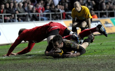 02.04.10 - Ospreys v Scarlets - Magners League - Tommy Bowe of Ospreys beats Rhys Priestland of Scarlets to score try. 