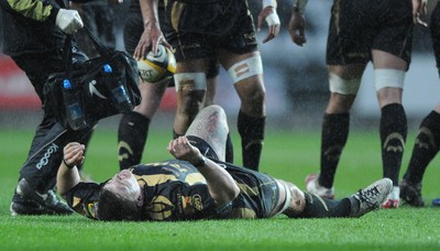 02.04.10 - Ospreys v Scarlets - Magners League - Richard Hibbard of Ospreys feels an injury before going off. 