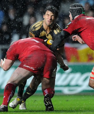 02.04.10 - Ospreys v Scarlets - Magners League - Mike Phillips of Ospreys takes on Iestyn Thomas and Lou Reed of Scarlets. 