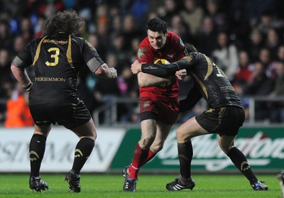 02.04.10 - Ospreys v Scarlets - Magners League - Stephen Jones of Scarlets is tackled by Dan Biggar of Ospreys. 