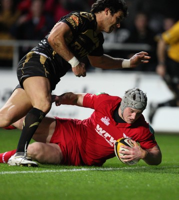 02.04.10 ... Ospreys v Scarlets, Magners League -  Jonathan Davies of Scarlets beats Mike Phillips of Ospreys to score try 