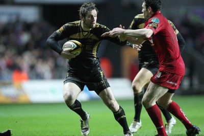 02.04.10 ... Ospreys v Scarlets, Magners League -  Andrew Bishop of Ospreys looks to hold off the challenge of Stephen Jones of Scarlets 