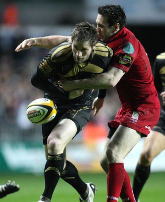 02.04.10 ... Ospreys v Scarlets, Magners League -  Andrew Bishop of Ospreys spills the ball as Stephen Jones of Scarlets tackles 