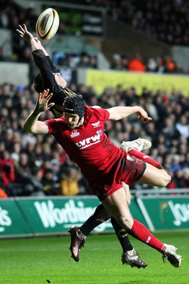 02.04.10 ... Ospreys v Scarlets, Magners League -  Andy Fenby of Scarlets and Tommy Bowe of Ospreys tangle as they attempt to win the high ball  