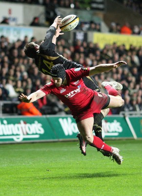 02.04.10 ... Ospreys v Scarlets, Magners League -  Andy Fenby of Scarlets and Tommy Bowe of Ospreys tangle as they attempt to win the high ball  