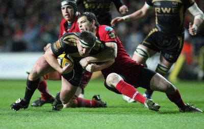 02.04.10 ... Ospreys v Scarlets, Magners League -  Huw Bennett of Ospreys is tackled by Sean Lamont of Scarlets 