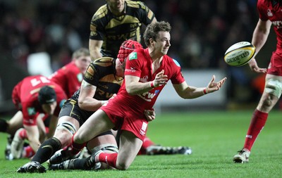 02.04.10 ... Ospreys v Scarlets, Magners League -  Martin Roberts of Scarlets releases the ball as Alun Wyn Jones of Ospreys tackles 