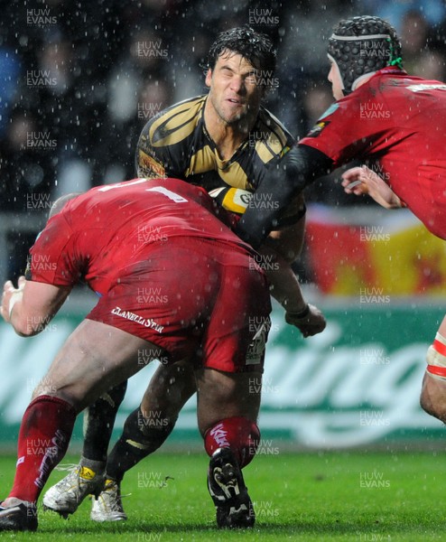 02.04.10 - Ospreys v Scarlets - Magners League - Mike Phillips of Ospreys takes on Iestyn Thomas and Lou Reed of Scarlets. 