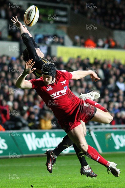 02.04.10 ... Ospreys v Scarlets, Magners League -  Andy Fenby of Scarlets and Tommy Bowe of Ospreys tangle as they attempt to win the high ball  