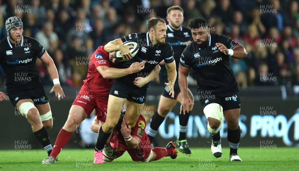 071017 - Ospreys v Scarlets - Guinness PRO14 - Cory Allen of Ospreys is tackled by Ken Owens and Will Boyde of Scarlets