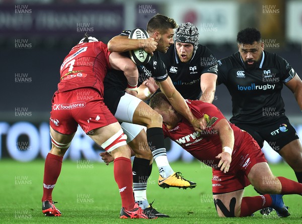 071017 - Ospreys v Scarlets - Guinness PRO14 - Rhys Webb of Ospreys is tackled by Will Boyde and Samson Lee of Scarlets