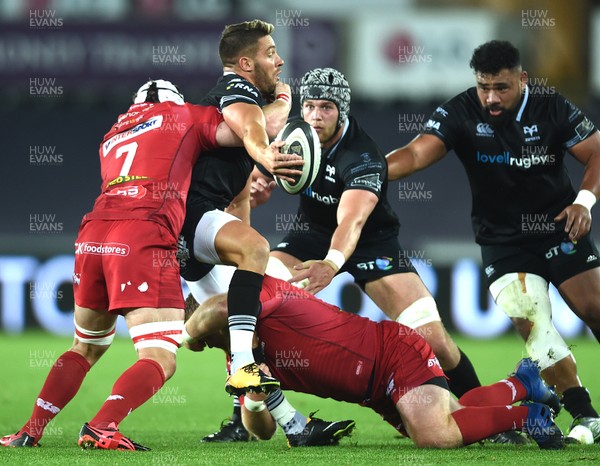 071017 - Ospreys v Scarlets - Guinness PRO14 - Rhys Webb of Ospreys is tackled by Will Boyde and Samson Lee of Scarlets