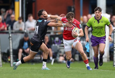 090526 - Ospreys v Scarlets - United Rugby Championship - Macs Page of Scarlets is challenged by Luke Morgan of Ospreys 