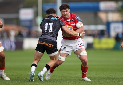 090526 - Ospreys v Scarlets - United Rugby Championship - Fletcher Anderson of Scarlets is tackled by Luke Morgan of Ospreys 