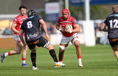 090526 - Ospreys v Scarlets - United Rugby Championship - Josh Macleod of Scarlets is challenged by Morgan Morris of Ospreys 
