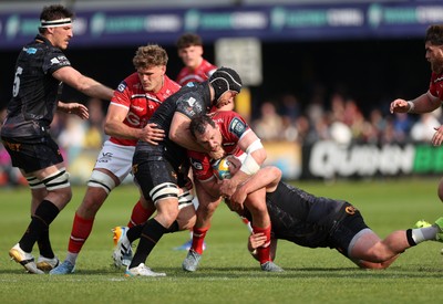090526 - Ospreys v Scarlets - United Rugby Championship - Ryan Elias of Scarlets is tackled by Morgan Morris of Ospreys 