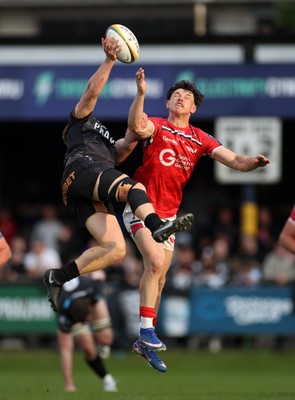 090526 - Ospreys v Scarlets - United Rugby Championship - Iestyn Hopkins of Ospreys and Tom Rogers of Scarlets go up for the ball