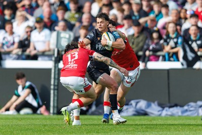 090526 - Ospreys v Scarlets - United Rugby Championship - Jack Walsh of Ospreys is tackled by Joe Roberts and Tom Rogers of Scarlets