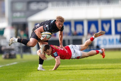 090526 - Ospreys v Scarlets - United Rugby Championship - Jac Morgan of Ospreys is tackled by Dane Blacker of Scarlets