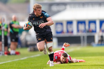 090526 - Ospreys v Scarlets - United Rugby Championship - Jac Morgan of Ospreys gets away from the tackle of by Dane Blacker of Scarlets