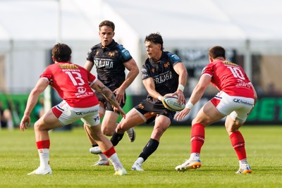 090526 - Ospreys v Scarlets - United Rugby Championship - Jack Walsh of Ospreys passes the ball
