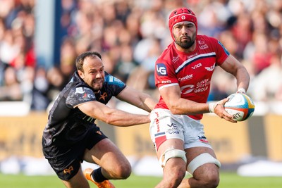 090526 - Ospreys v Scarlets - United Rugby Championship - Eddie James of Scarlets is tackled by Evade Boshoff of Ospreys