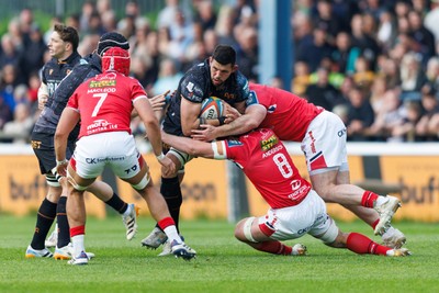 090526 - Ospreys v Scarlets - United Rugby Championship - Rhys Davies of Ospreys is tackled by Fletcher Anderson of Scarlets