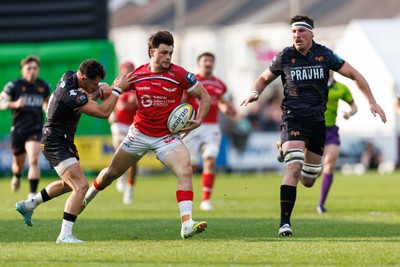 090526 - Ospreys v Scarlets - United Rugby Championship - Joe Roberts of Scarlets hands off Luke Morgan of Ospreys