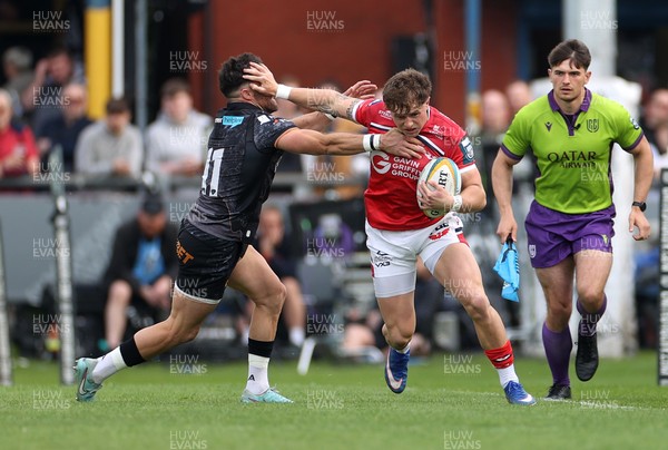 090526 - Ospreys v Scarlets - United Rugby Championship - Macs Page of Scarlets is challenged by Luke Morgan of Ospreys 