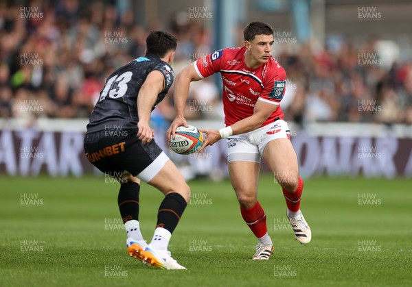090526 - Ospreys v Scarlets - United Rugby Championship - Joe Hawkins of Scarlets is challenged by Owen Watkin of Ospreys 