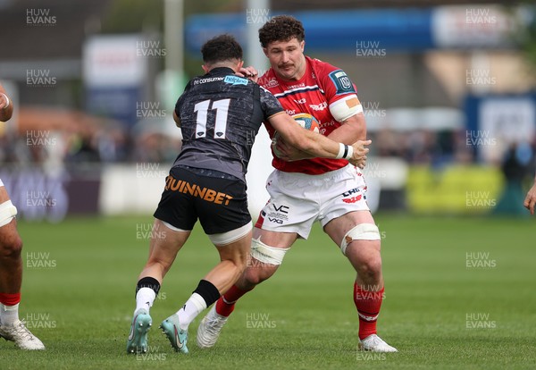 090526 - Ospreys v Scarlets - United Rugby Championship - Fletcher Anderson of Scarlets is tackled by Luke Morgan of Ospreys 