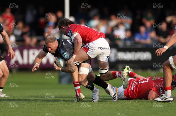 090526 - Ospreys v Scarlets - United Rugby Championship - Ross Moriarty of Ospreys is tackled by Max Douglas of Scarlets 