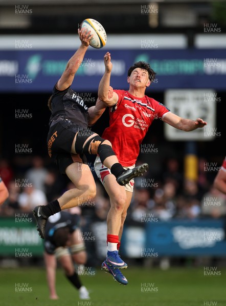 090526 - Ospreys v Scarlets - United Rugby Championship - Iestyn Hopkins of Ospreys and Tom Rogers of Scarlets go up for the ball