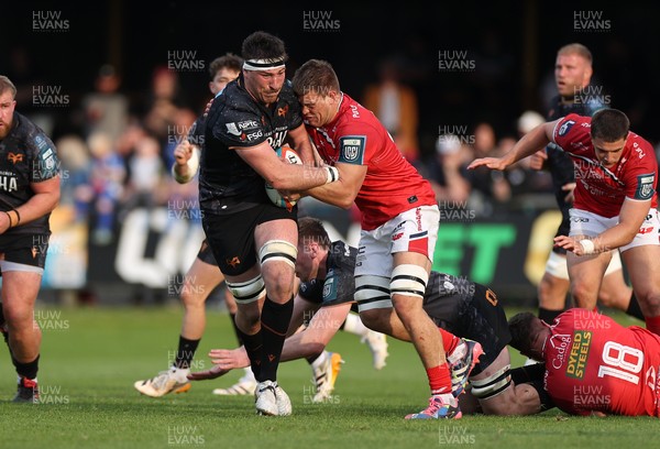 090526 - Ospreys v Scarlets - United Rugby Championship - Ryan Smith of Ospreys is tackled by Jarrod Taylor of Scarlets 