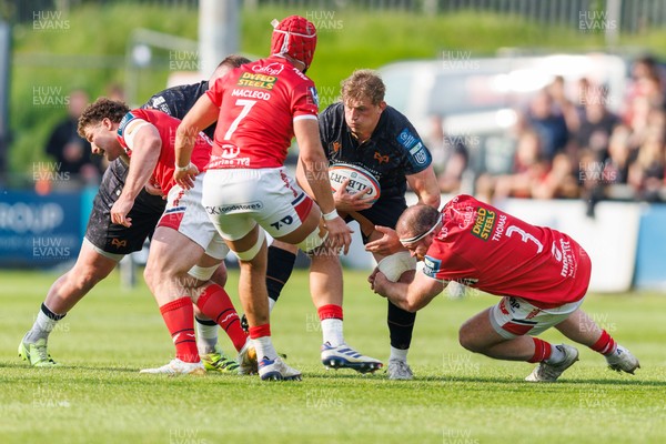 090526 - Ospreys v Scarlets - United Rugby Championship - Jac Morgan of Ospreys is tackled by Henry Thomas of Scarlets