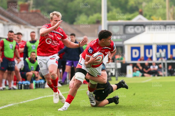 090526 - Ospreys v Scarlets - United Rugby Championship - Dan Davis of Scarlets is tackled by Iestyn Hopkins of Ospreys