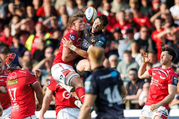 090526 - Ospreys v Scarlets - United Rugby Championship - Taine Plumtree of Scarlets and Jack Walsh of Ospreys compete for a high ball