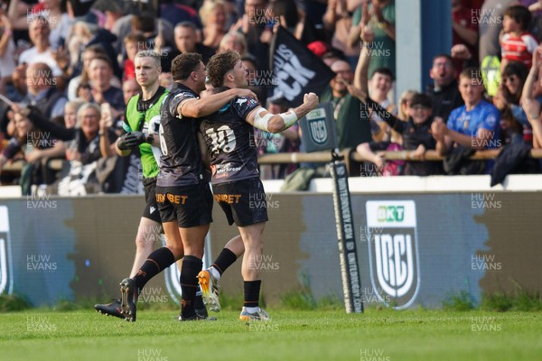 090526 - Ospreys v Scarlets - United Rugby Championship - Dan Edwards and Lewis Lloyd of Ospreys celebrate with fans at the end of the match