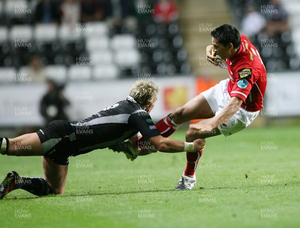 11.09.07 Ospreys v Scarlets... ScarletsRegan King is tackled by Justin Marshall 