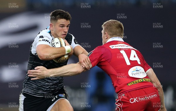 180519 - Ospreys v Scarlets - European Champions Cup Play off - Owen Watkin of Ospreys is tackled by Johnny McNicholl of Scarlets