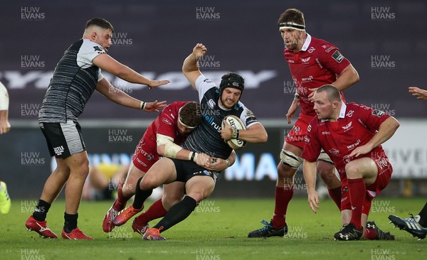 180519 - Ospreys v Scarlets - European Champions Cup Play off - Dan Evans of Ospreys is tackled by Phil Price of Scarlets