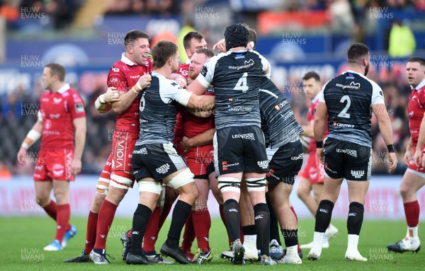 221218 - Ospreys v Scarlets - Guinness PRO14 - Both sets of players during an exchange