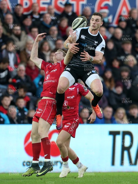 221218 - Ospreys v Scarlets - Guinness PRO14 - George North of Ospreys and Johnny McNicholl of Scarlets go up for the ball